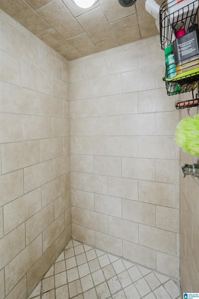 full bath with a tile shower