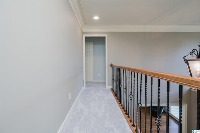 hall featuring recessed lighting, crown molding, and baseboards