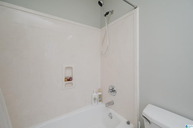 bathroom featuring shower / bathtub combination and toilet