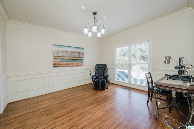 office area featuring a chandelier, a wainscoted wall, ornamental molding, and wood finished floors