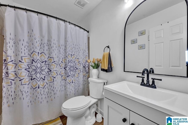 bathroom featuring visible vents, vanity, and toilet