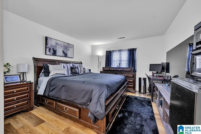 bedroom featuring visible vents and light wood-style flooring