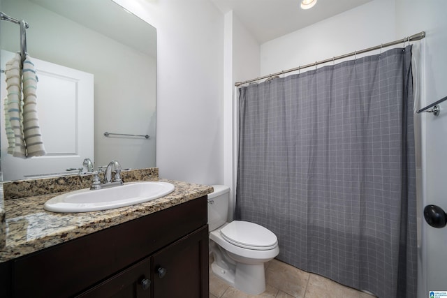 bathroom with toilet, curtained shower, vanity, and tile patterned floors