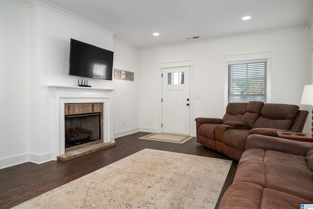 living area featuring ornamental molding, dark wood-style flooring, visible vents, and baseboards