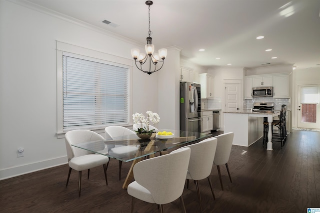 dining space with visible vents, baseboards, dark wood-style flooring, crown molding, and a notable chandelier