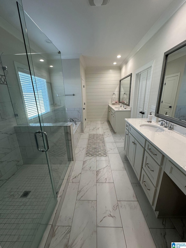 full bathroom featuring a stall shower, marble finish floor, two vanities, and a sink