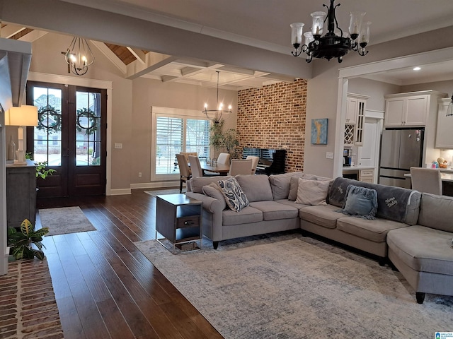 living room with an inviting chandelier, baseboards, dark wood-type flooring, and beamed ceiling