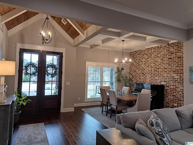 foyer entrance featuring baseboards, french doors, dark wood-style flooring, and an inviting chandelier