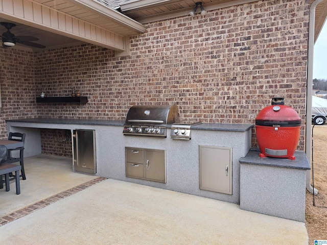 view of patio with an outdoor kitchen and a grill