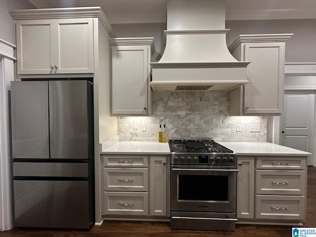 kitchen featuring custom exhaust hood, appliances with stainless steel finishes, light countertops, and backsplash