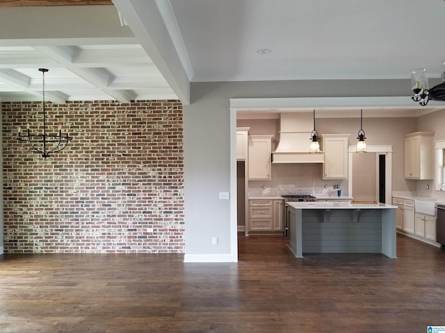 kitchen featuring brick wall, dark wood-style flooring, light countertops, premium range hood, and beam ceiling