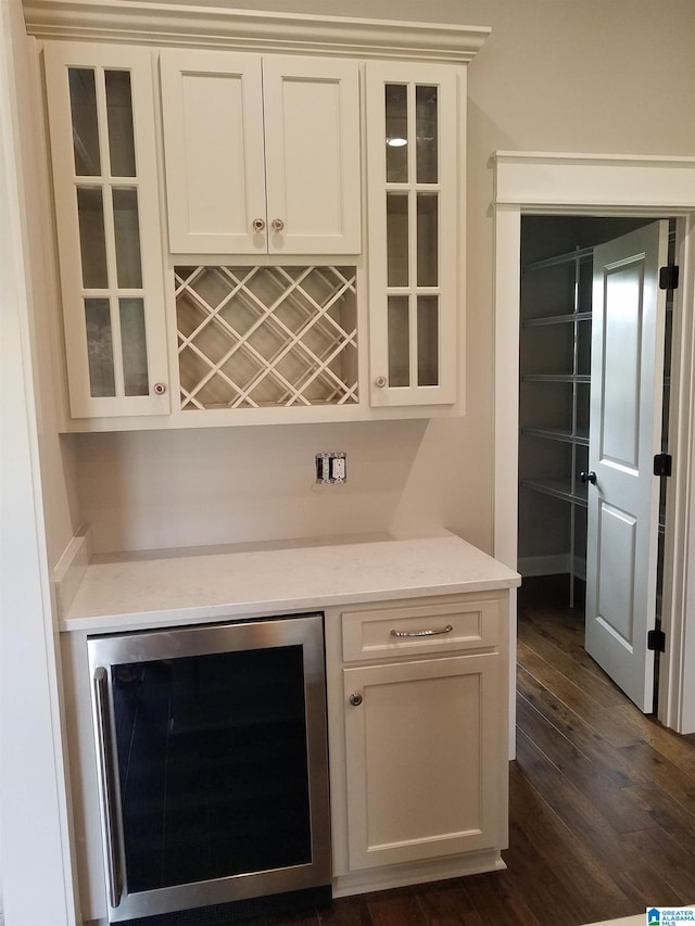 bar featuring a dry bar, wine cooler, and dark wood finished floors