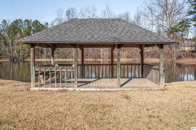 dock area with a water view and a lawn