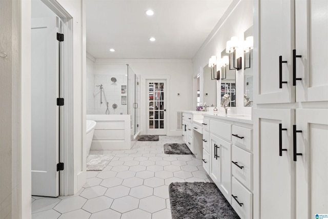 bathroom with recessed lighting, vanity, a freestanding bath, ornamental molding, and a shower stall