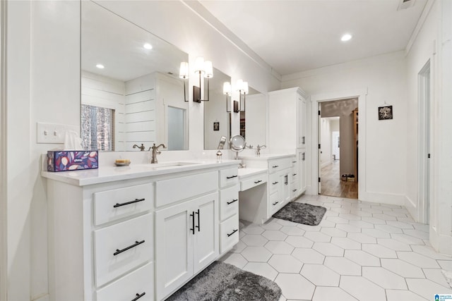 bathroom featuring recessed lighting, ornamental molding, baseboards, and vanity