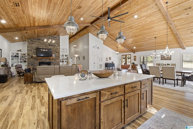 kitchen with light countertops, a center island, open floor plan, and decorative light fixtures