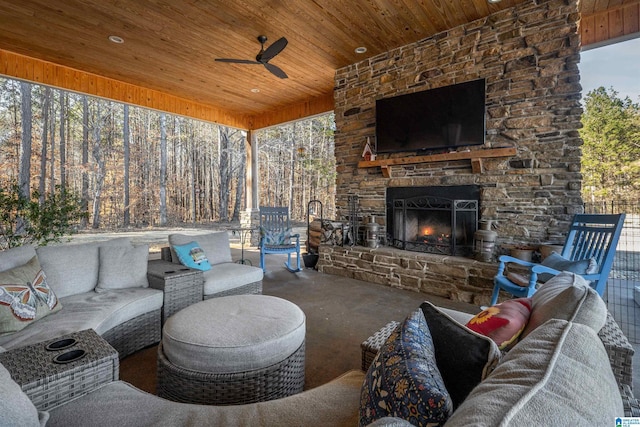 view of patio / terrace featuring ceiling fan and an outdoor living space with a fireplace