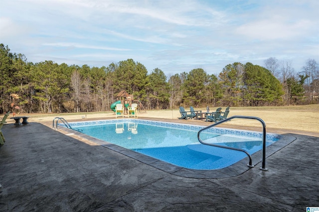 pool with playground community and a patio