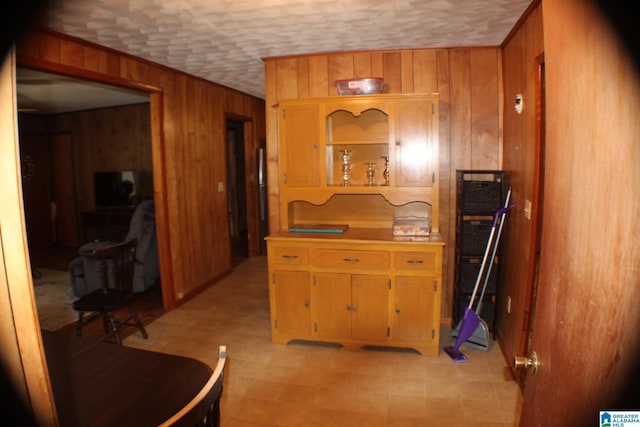 kitchen featuring light countertops and wood walls