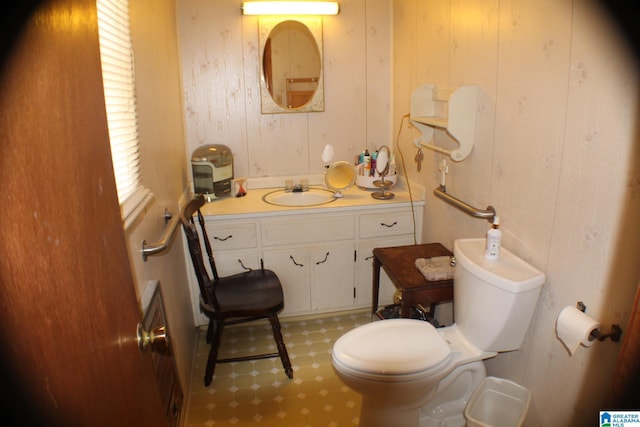 half bathroom featuring toilet and vanity