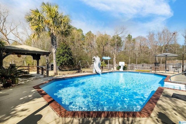 view of pool with a fenced in pool, a gazebo, a patio area, fence, and a water slide