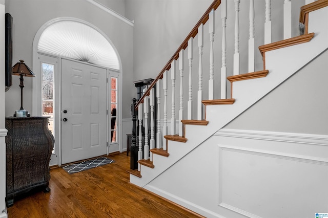 entrance foyer featuring stairs and wood finished floors