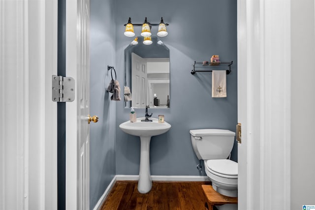 bathroom featuring wood finished floors, toilet, and baseboards