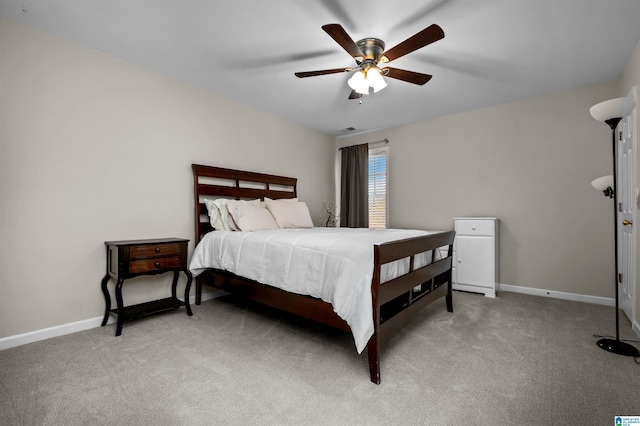 bedroom with light carpet, ceiling fan, and baseboards