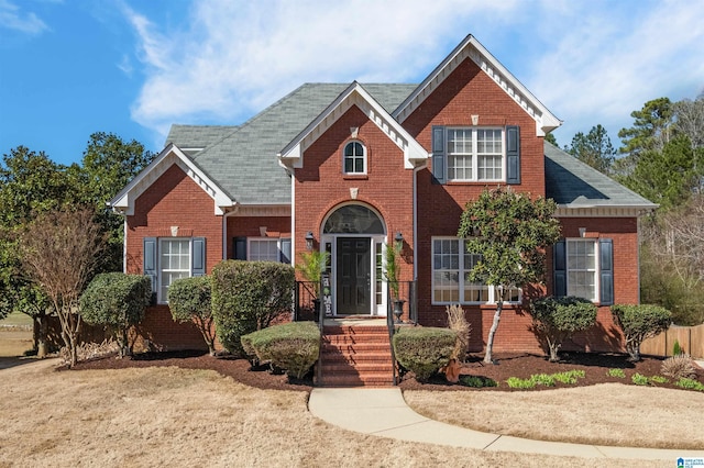 traditional-style home featuring brick siding