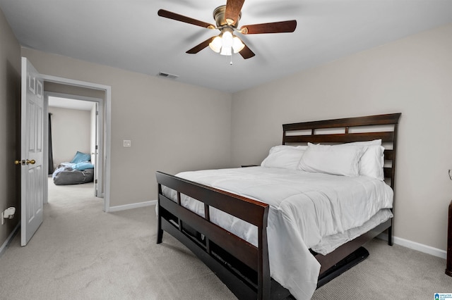 bedroom featuring light carpet, visible vents, and baseboards