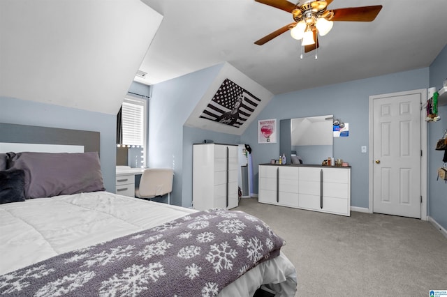 bedroom featuring a ceiling fan, baseboards, vaulted ceiling, and carpet flooring