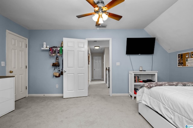 bedroom with baseboards, visible vents, a ceiling fan, light colored carpet, and lofted ceiling