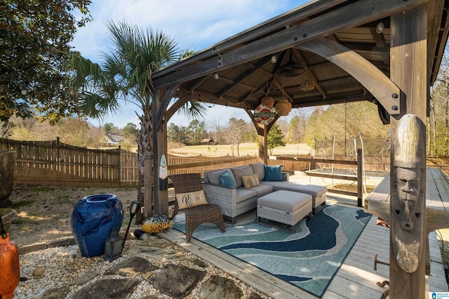 wooden deck featuring a fenced backyard, a patio, a gazebo, and an outdoor hangout area