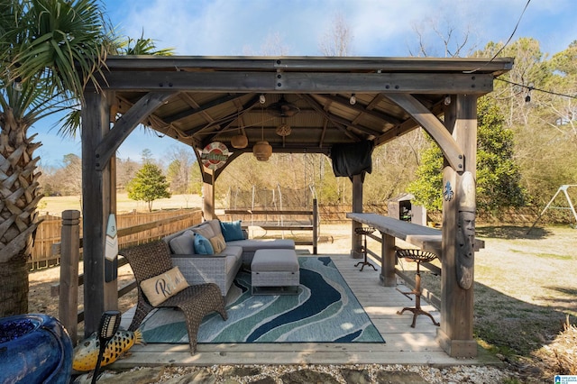 view of patio / terrace featuring fence, an outdoor hangout area, and a gazebo