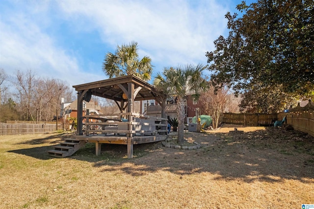 view of yard with a deck, a gazebo, and a fenced backyard