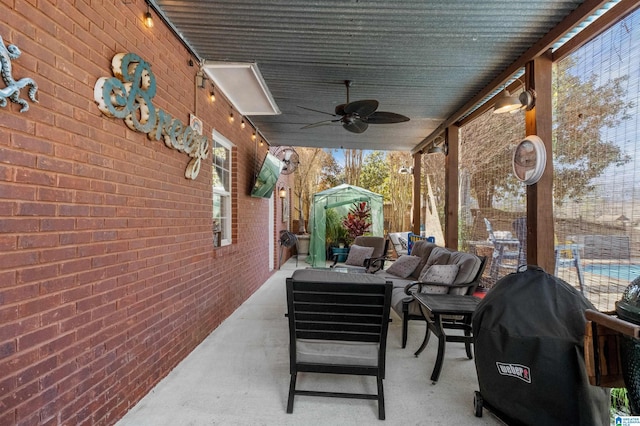 view of patio / terrace featuring ceiling fan, a grill, a storage unit, an outdoor structure, and an outdoor living space