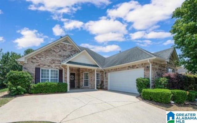 view of front of home with a garage, driveway, and brick siding