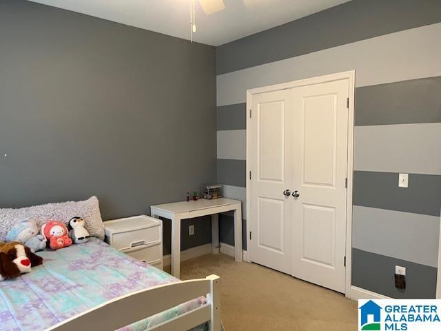 bedroom with baseboards, ceiling fan, and light colored carpet