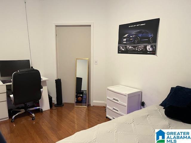 bedroom with dark wood finished floors