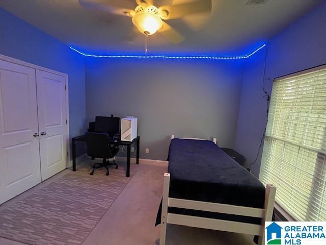 bedroom featuring baseboards, a ceiling fan, and carpet flooring