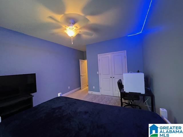 bedroom featuring a closet, ceiling fan, and baseboards