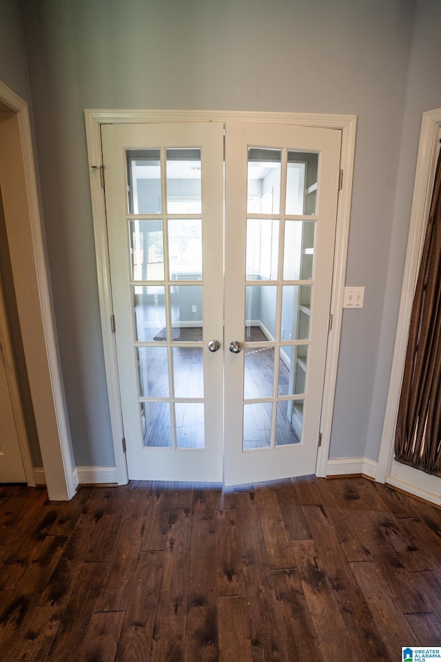 doorway to outside featuring dark wood-style flooring, baseboards, and french doors