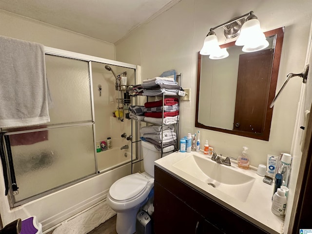 bathroom with toilet, ornamental molding, shower / bath combination with glass door, and vanity