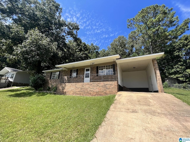 ranch-style house with an attached carport, concrete driveway, brick siding, and a front yard