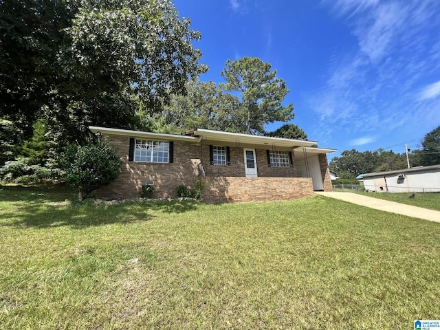 single story home featuring a front lawn, concrete driveway, brick siding, and crawl space