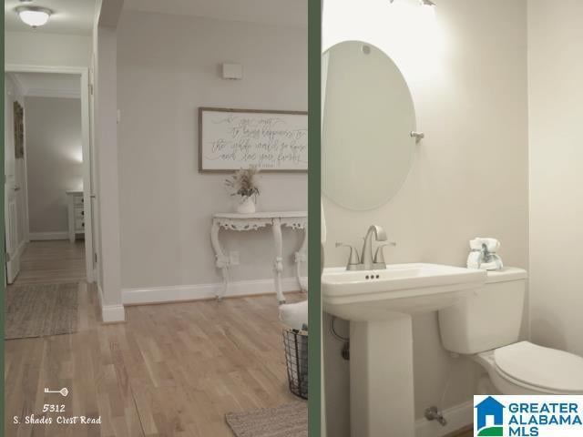 bathroom with baseboards, toilet, and wood finished floors