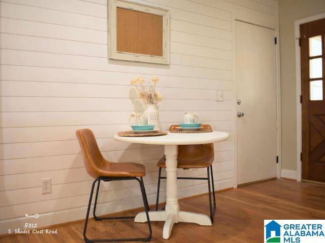 dining space featuring baseboards and wood finished floors