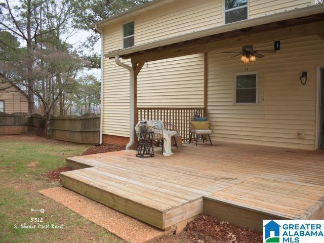 wooden deck featuring ceiling fan and fence