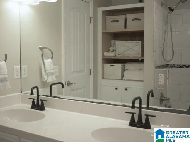 bathroom with double vanity, a sink, and bathing tub / shower combination