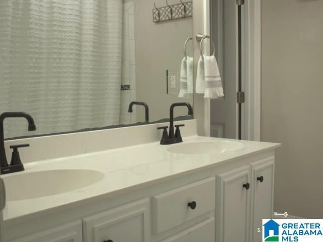 bathroom featuring double vanity, a sink, and a shower with curtain